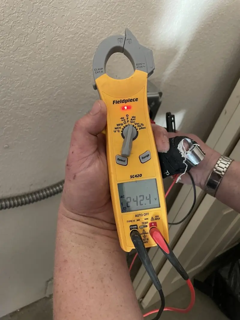 Voltage testing with clamp meter during Outlet Installation in St. Clair